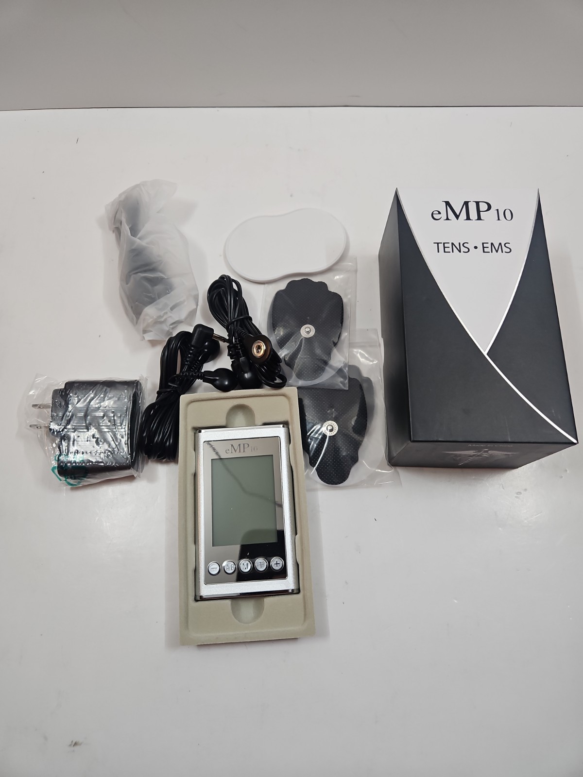 eMP10 TENS/EMS Portable unit in Silver Brand new sealed box w/ 4 extra new pads