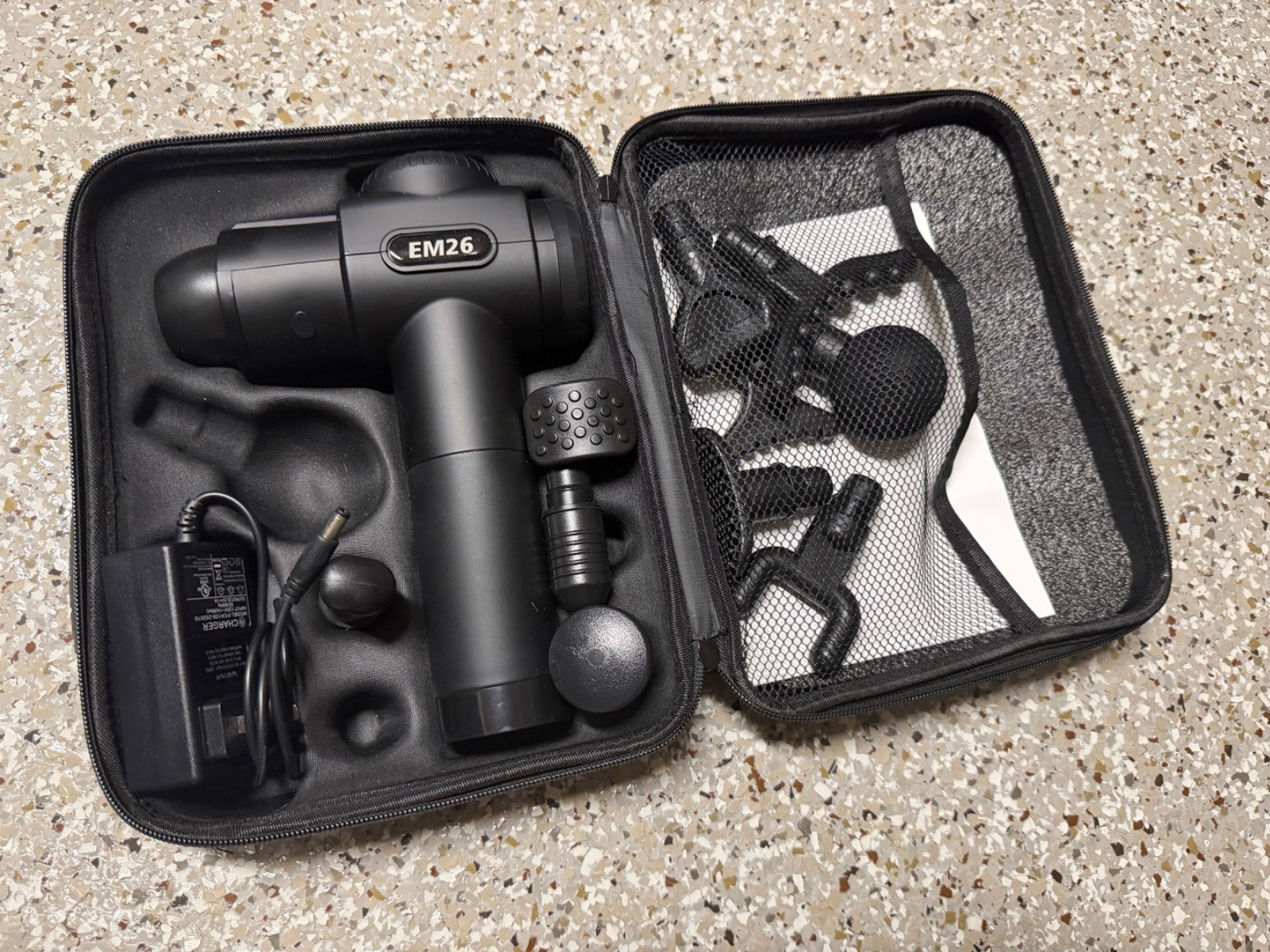 Massage Gun EM26 with various accessories.