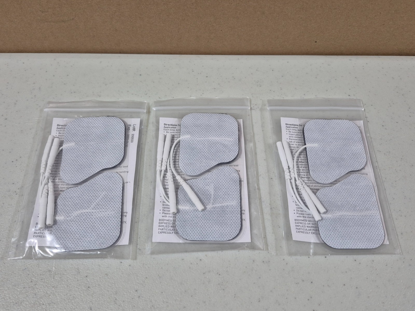 x12) BodyMed Self-Adhering Electrodes with tabs, 2″×2″ square ( TENS / EMS)